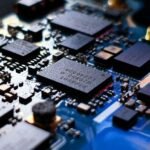 Close-up of a blue printed circuit board with electronic components