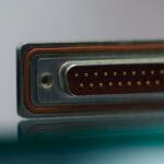 Close-up of an electronic connector and reflective metal surface