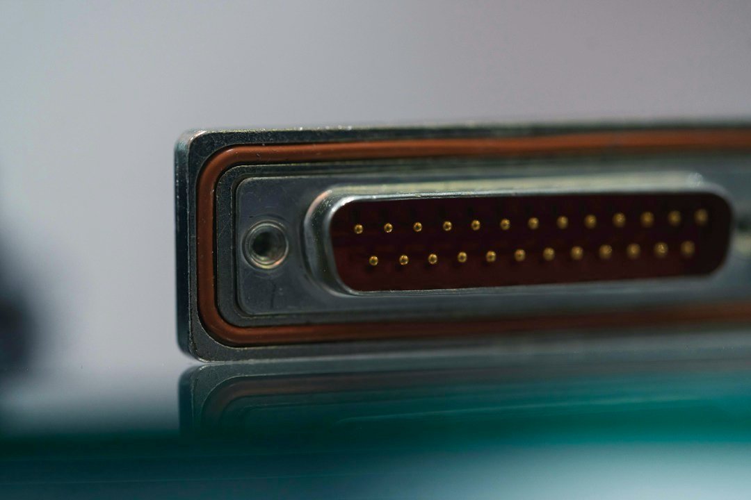 Close-up of an electronic connector and reflective metal surface